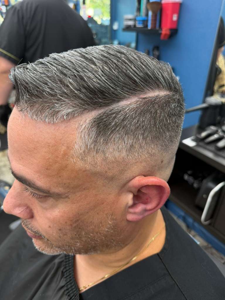 Alex Urbaez professional barber working on a precision fade in Gainesville FL